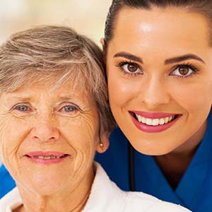 Smiling nurse with an elderly patient